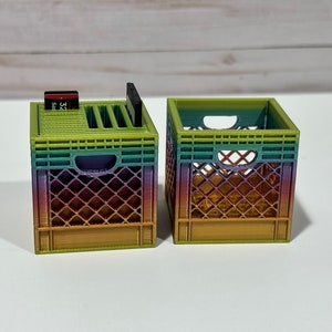 May include: Two small rainbow-colored plastic crates. One crate has a slot for holding SD cards and the other is empty.