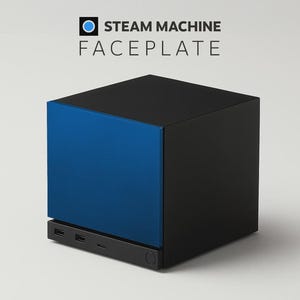 May include: A black and blue Steam Machine faceplate featuring a square design. The text STEAM MACHINE FACEPLATE is printed above the device, which has a solid blue front panel, a black frame, and a bottom section with visible ports and a circular button.