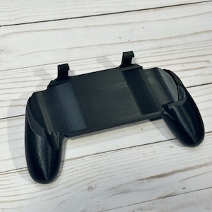 May include: A black 3D printed phone game controller with adjustable side grips.