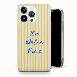 May include: A clear phone case with a yellow and white striped pattern. The words "La Dolce Vita" are written in blue script. The phone case is on a white background.