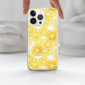 May include: A clear phone case with a pattern of yellow lemon slices on a white background. The case has a cutout for the camera lens.