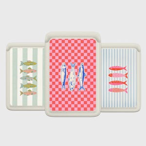 May include: Three decorative card holders with fish designs. One has a red and pink checkered pattern with three blue fish. Another has vertical stripes with colorful fish. The third has green and white stripes with fish.
