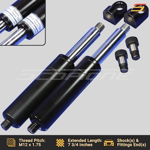May include: Two black gas struts with silver rods and black fittings. The struts are 7 3/4 inches long and have an M12 x 1.75 thread pitch. The text on the struts reads "Force: Choose Yours lbs High Pressure Do Not Open".