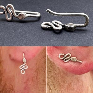 May include: Silver-toned ear cuff and earring set. The ear cuff features a curved design with a snake-like shape. The earring has a similar snake design. The bottom images show the jewelry being worn.