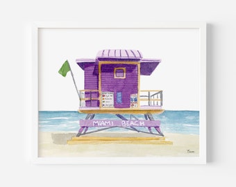 May include: Watercolor painting of a purple lifeguard stand on a sandy beach with the text "Miami Beach". A green flag flies from the stand. The stand has a small window and a sign with text. The ocean is in the background.