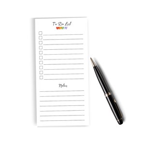 May include: A white to-do list notepad with a rainbow of hearts at the top and the words "To Do List" written in black. The notepad has lines for writing and a section labeled "Notes".