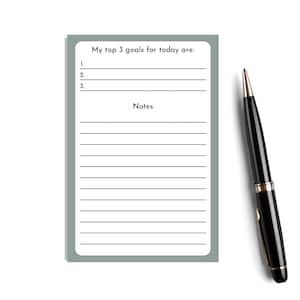 May include: A white lined notepad with a gray border. The notepad has the text "My top 3 goals for today are:" and a section for notes.