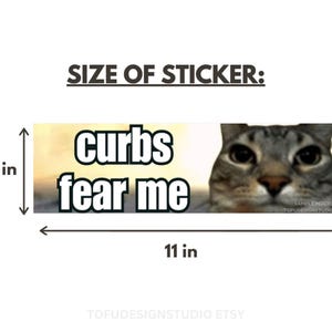 May include: A rectangular sticker featuring a gray tabby cat face on the right and the text "curbs fear me" in bold white letters with black outlines on the left. The sticker measures 3 inches by 11 inches as indicated by the visible dimension lines.