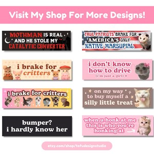 May include: A collection of eight colorful bumper stickers featuring various cat and animal illustrations and text. The stickers include phrases like "Mothman is real", "I brake for critters", "True Patriots Brake for America's Only Native Marsupial", and "When you honk at me this is who you're honking at".