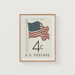 May include: Framed print of a vintage U.S. postage stamp. The stamp features a waving American flag with a field of stars and red and white stripes. The text "JULY 4, 1960" and "4¢ U.S. POSTAGE" are also displayed.