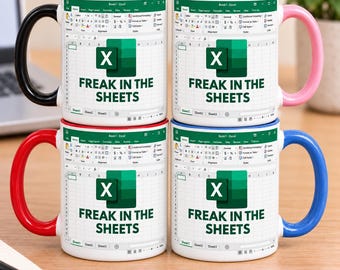 May include: Four ceramic mugs featuring a white background with a printed Microsoft Excel spreadsheet interface and the green Excel logo. The text "FREAK IN THE SHEETS" is printed in dark green. Each mug has a different coloured handle: black, pink, red, and blue.