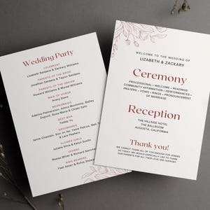 May include: Two white wedding programs with burgundy text and floral accents. The programs list the wedding party, ceremony details, and reception information. The programs are on a gray surface.
