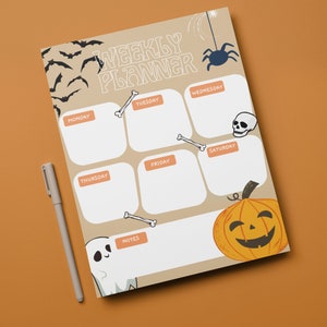 May include: A weekly planner with a Halloween theme. The planner has a beige background with black bats, a spider, a skull, bones, a ghost, and a pumpkin. The days of the week are listed at the top of the planner: Monday, Tuesday, Wednesday, Thursday, Friday, Saturday. There is a notes section at the bottom of the planner.