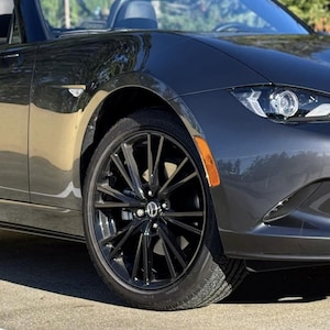 May include: A rustic wooden sign with the text "Welcome to our home" in white lettering. The sign features a distressed finish and a simple, inviting design, perfect for a front porch or entryway.