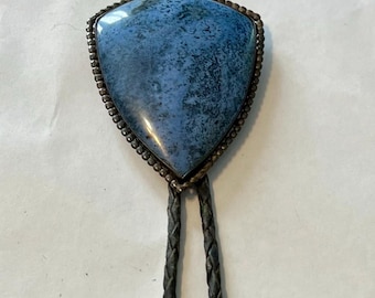 Vintage Zuni Bolo Tie | Features striking shield-shaped blue cabochon within detailed, beaded sterling silver bezel | braided leather cord