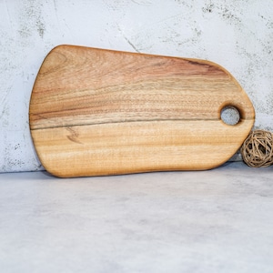 Oval bread or cheese board in camphor laurel timber. Measures 35 x 20 x 2 cms