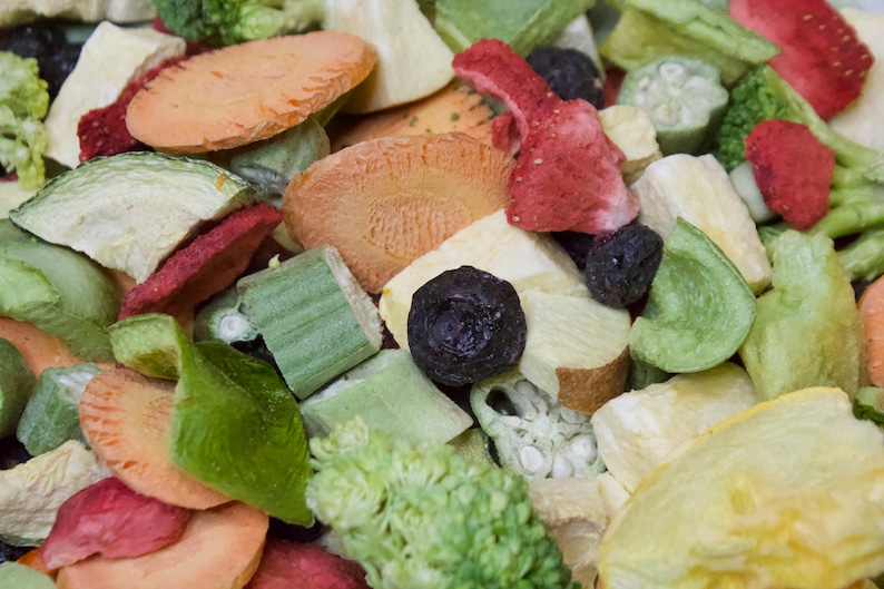 May include: A mix of dried fruits and vegetables, including carrots, zucchini, strawberries, and blueberries. The dried fruits and vegetables are a variety of colors, including red, orange, yellow, green, and purple.

“Premium freeze-dried bird food by Runzas made with real fruits and vegetables for parrots”