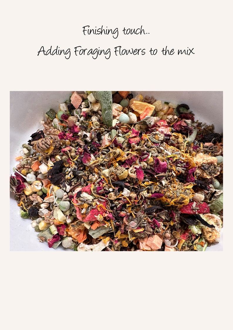 May include: A close-up of a bowl filled with a colorful mix of dried fruits, vegetables, and flowers. The mix includes dried orange slices, dried apple pieces, dried cranberries, dried rose petals, and other dried flowers.