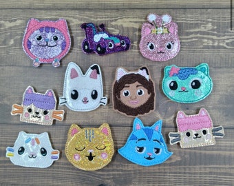 May include: A set of 12 colorful felt patches featuring various cartoon characters, including cats, a race car, and a girl with brown hair. The patches are perfect for adding a whimsical touch to clothing, bags, or other crafts.