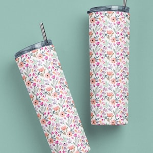 May include: Two stainless steel tumblers with lids and straws. Both tumblers feature a floral pattern with pink, orange, and purple flowers on a white background.