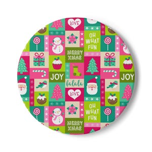 May include: A circular decorative item featuring a colorful grid pattern with Christmas-themed illustrations including snowmen, Santa Claus, Christmas trees, gifts, candy canes, cupcakes, and text reading LOVE, OH WHAT FUN, MERRY XMAS, JOY, and falala.