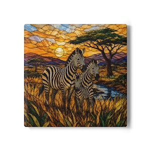 May include: A square wall art piece featuring a stained glass style illustration of three zebras standing in tall grass. The scene depicts a sunset with orange and yellow clouds, a large acacia tree, and a small stream under a bright sun.
