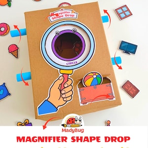 May include: A brown cardboard box game titled Magnifier Shape Drop featuring a large illustrated magnifying glass with a purple border and the word CIRCLE. The box includes a hand graphic, a red chest with a beach ball, and various small cutouts.