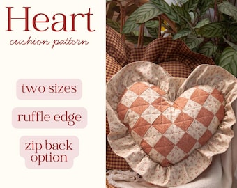 May include: A heart-shaped cushion with a quilted design in shades of peach and cream, featuring a ruffle edge. The text "Heart cushion pattern" is displayed above the cushion, with options for "two sizes", "ruffle edge", and a "zip back option".