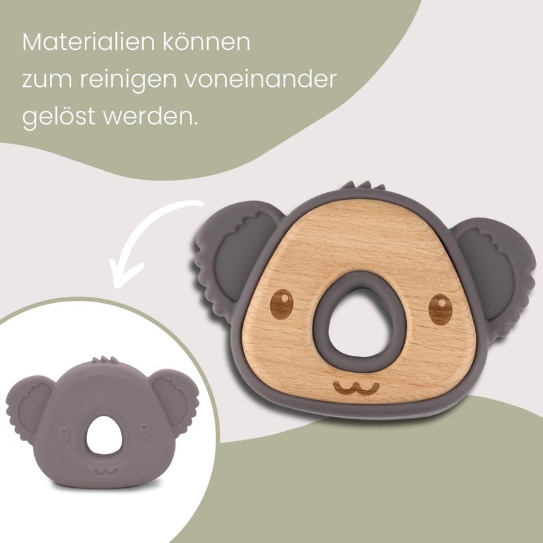 May include: A koala-shaped baby teether with a wooden center and gray silicone accents. The teether has a circular opening in the center and is designed to be easy for babies to grasp. The image also includes the text: "Materialien k&ouml;nnen zum reinigen voneinander gel&ouml;st werden."