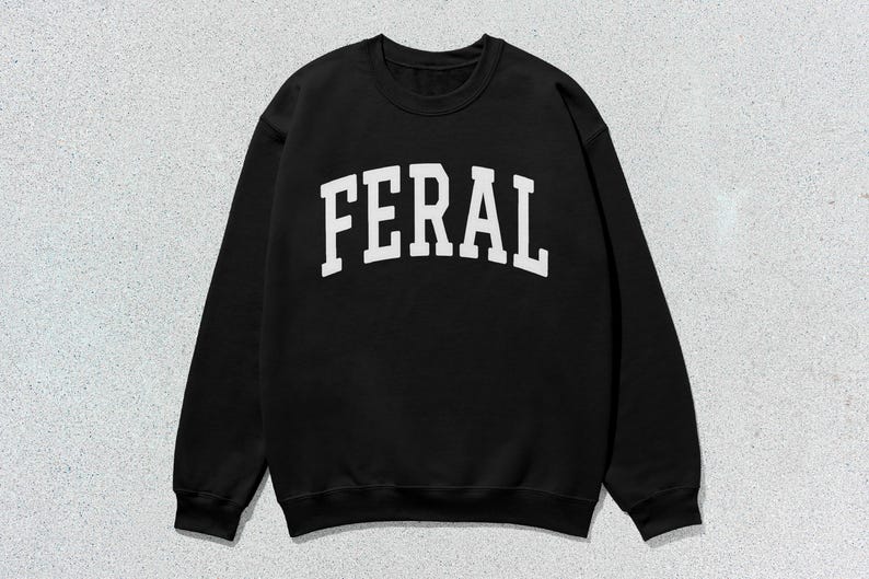 May include: Black sweatshirt with a white "FERAL" graphic printed on the front.
