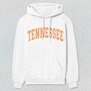 May include: White hooded sweatshirt with the word "TENNESSEE" printed in orange on the front.