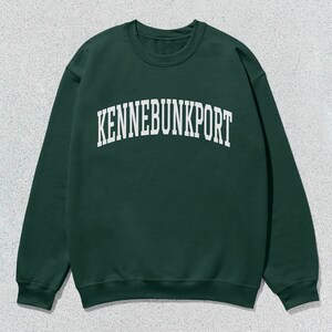 May include: A dark green sweatshirt with the text "KENNEBUNKPORT" in white.