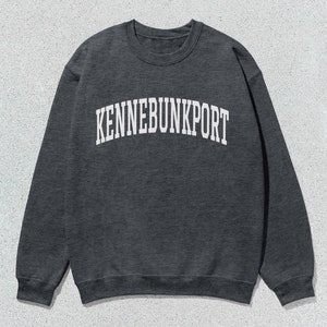 May include: A dark gray sweatshirt with the text "KENNEBUNKPORT" printed in white on the front.
