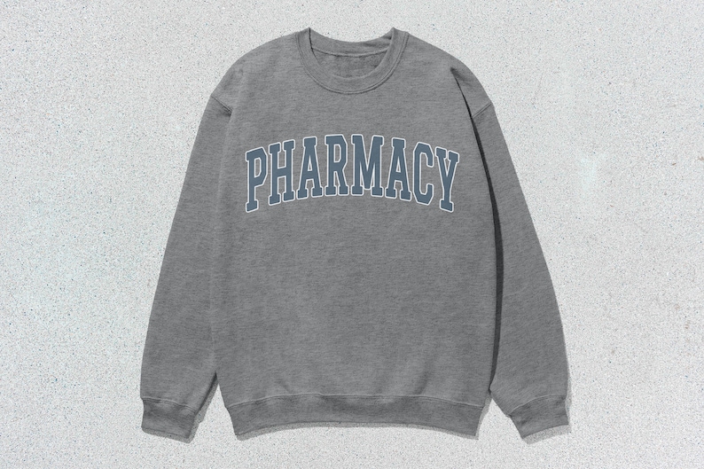 May include: A gray sweatshirt with the word "PHARMACY" printed in blue on the front.