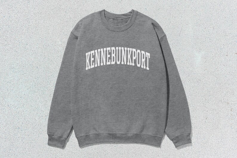 May include: Gray sweatshirt with the text "KENNEBUNKPORT" in white.