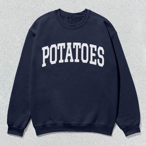 May include: A navy blue sweatshirt with the word "POTATOES" printed in white on the front.