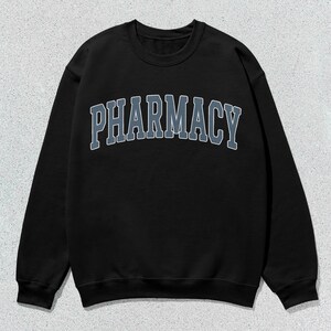 May include: Black sweatshirt with a gray "PHARMACY" graphic in a collegiate font.