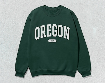 May include: A dark green sweatshirt with white text that reads "OREGON USA".