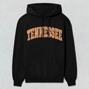 May include: Black hooded sweatshirt with an orange "TENNESSEE" graphic on the front.