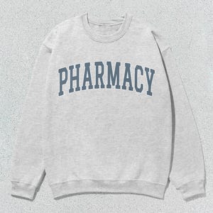 May include: A gray sweatshirt with the word "PHARMACY" printed in blue on the front.