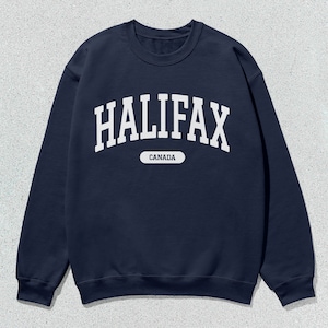 May include: A navy blue sweatshirt with white text that reads "HALIFAX CANADA" in an arched font.