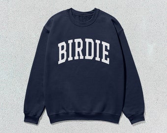 May include: A navy blue sweatshirt with the word "BIRDIE" printed in white on the front.