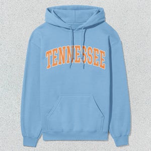 May include: A light blue hoodie with a large orange "TENNESSEE" graphic on the front.