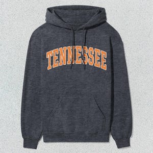 May include: A dark gray hooded sweatshirt with the word "TENNESSEE" printed in orange on the front.