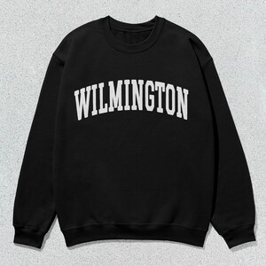 May include: Black sweatshirt with white text that reads "WILMINGTON" in a collegiate font.