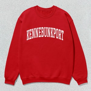 May include: Red sweatshirt with white text that reads "KENNEBUNKPORT" in an arched font.