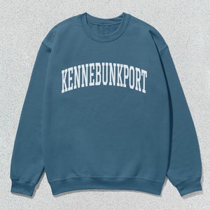 May include: A blue sweatshirt with the text "KENNEBUNKPORT" in white.