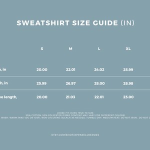 May include: A size chart for sweatshirts in inches, showing width, length, and sleeve length measurements for sizes S, M, L, XL, and 2XL.  The chart includes the text "Loose fit runs true to size".