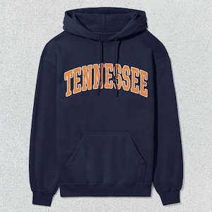 May include: A navy blue hooded sweatshirt with the word "TENNESSEE" printed in orange on the front.