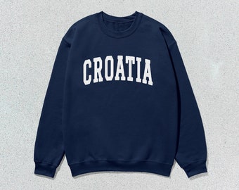 Op de afbeelding: Een marineblauw sweatshirt met het woord "CROATIA" in wit op de voorkant.